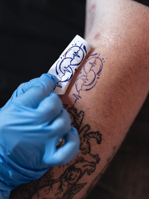 Ein auf einem Oberarm frisch gestochenes Tattoo in Herzschlagform, das für die Organspende sensibilisieren will. Ein auf einem Oberarm frisch gestochenes Tattoo in Herzschlagform, das für die Organspende sensibilisieren will.