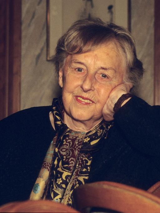 Carola Stern mit kurzen, weißen Haaren sitzt in einer Farbfotografie leger und stützt ihren Kopf mit der linken Hand. Dabei schaut sie lächelnd in die Kamera. Carola Stern mit kurzen, weißen Haaren sitzt in einer Farbfotografie leger und stützt ihren Kopf mit der linken Hand. Dabei schaut sie lächelnd in die Kamera.