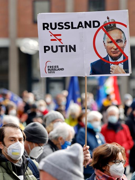 Demonstrierende in Köln. Auf ihren Schildern steht "Russland ist nicht Putin" und "Russen gegen den Krieg".