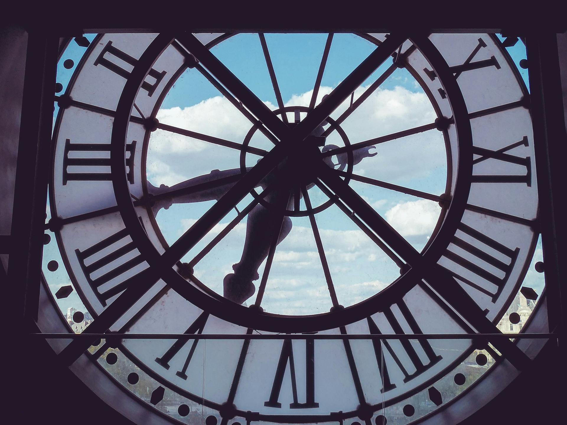 Blick durch ein riesiges Uhrenziffernblatt in den Himmel