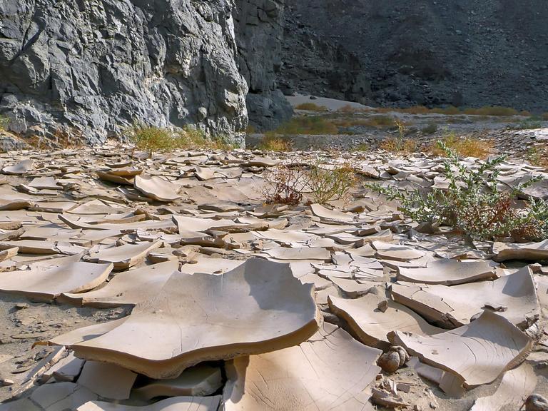 Trockenes Flussbett mit zerbrochenem, lehmartigem Boden in einer Wüstenumgebung in Ägypten. Trockenes Flussbett mit zerbrochenem, lehmartigem Boden in einer Wüstenumgebung in Ägypten.