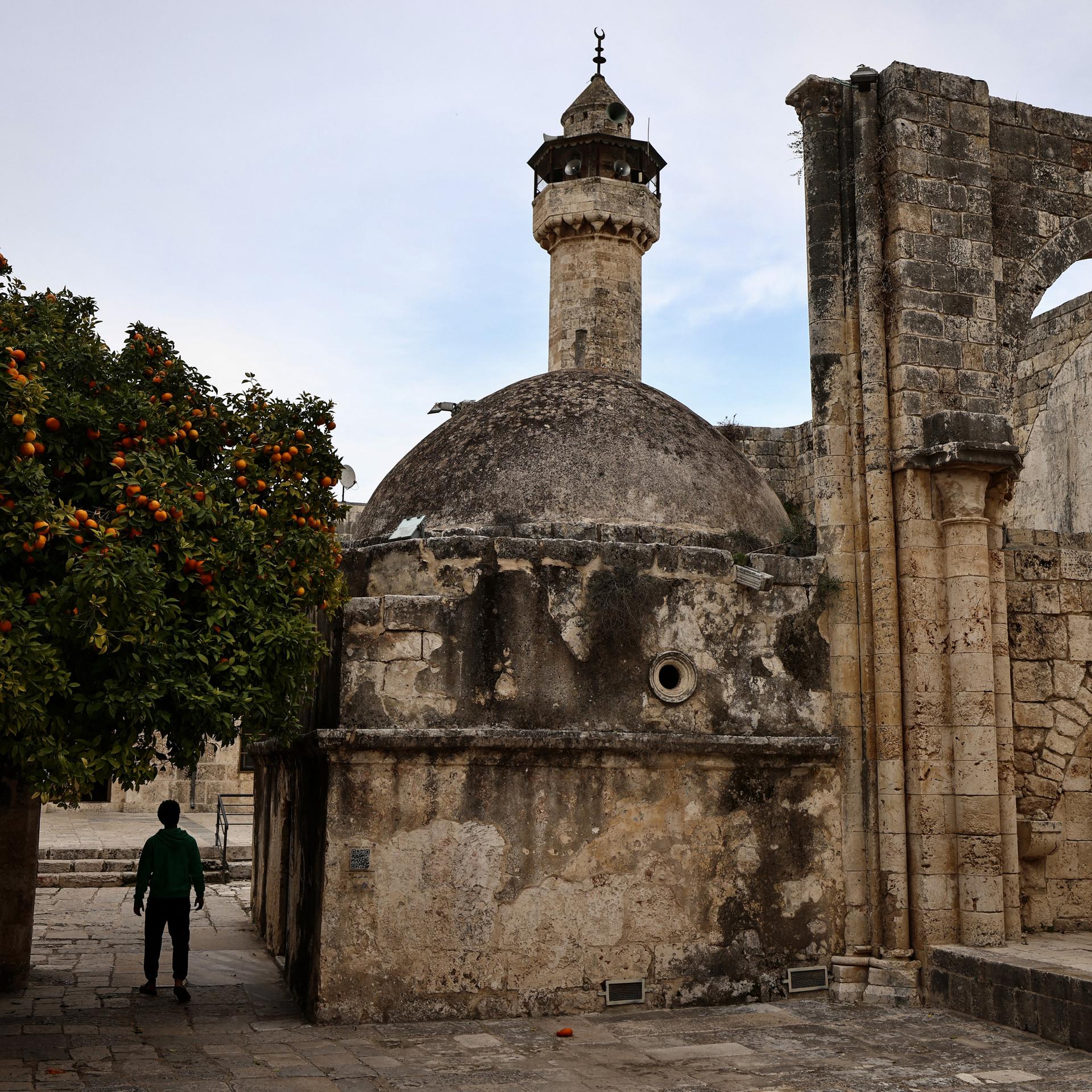 Ein junger Mann geht am 12. Februar 2026 durch die alte, historische Moschee im Dorf Sebastia westlich der in der besetzten Westbank gelegenen Stadt Nablus.