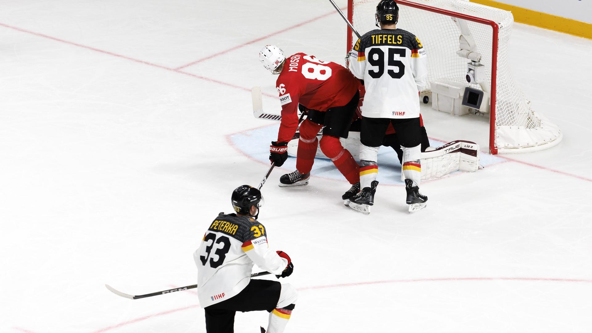 Lettland, Riga: Eishockey: WM, Schweiz - Deutschland, Finalrunde, Viertelfinale in der Arena Riga: John Peterka (l) aus Deutschland trifft zum 1:2.