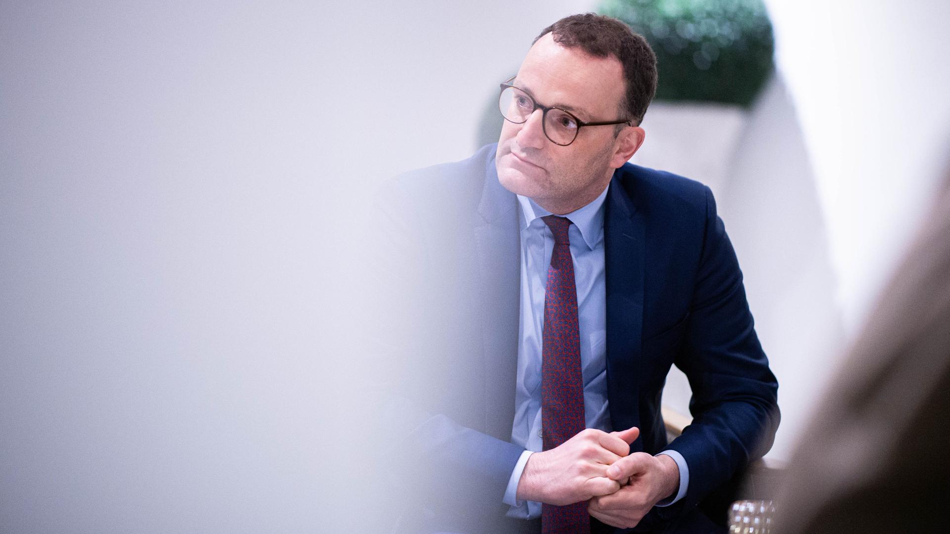 Jens Spahn (CDU) sitzt auf einem Stuhl