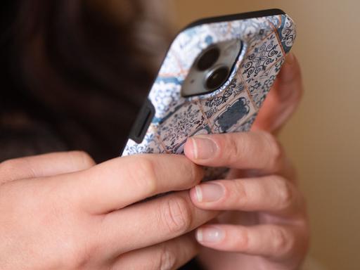 Zwei Hände tippen auf einem Smartphone