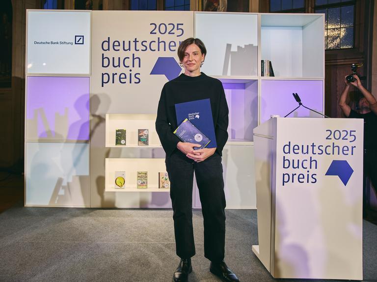 Die Autorin Dorothee Elmiger steht nach der Preisverleihung mit ihrem Buch auf der Bühne.