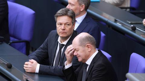Olaf Scholz, Robert Habeck und Christian Lindner in missvergnüglicher Pose während der 149. Sitzung im Deutschen Bundestag.