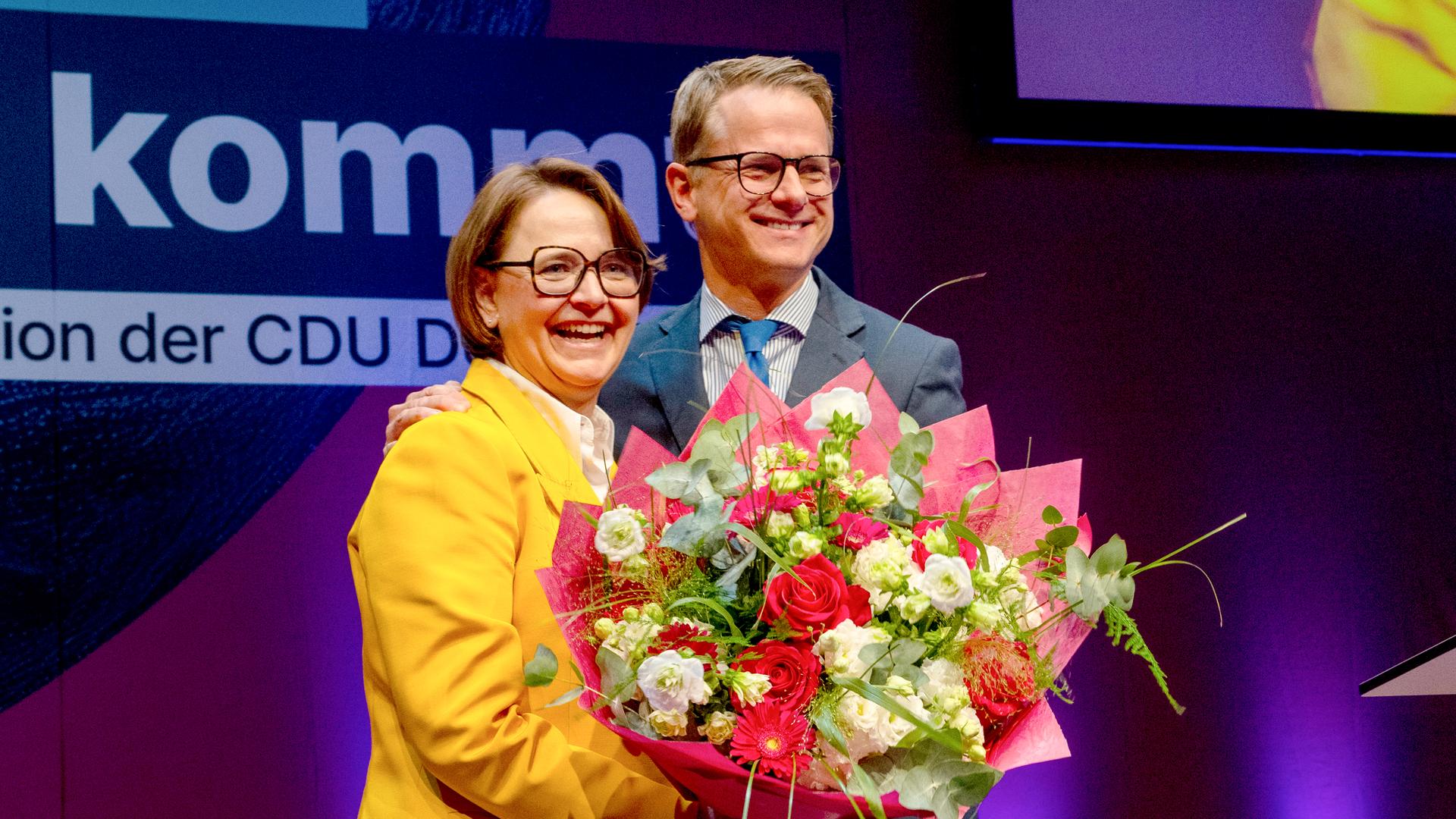 CDU-Generalsekretär Carsten Linnemann verabschiedet die bisherige Vorsitzende der Frauen-Union, Annette Widmann-Mauz. Er überreicht ihr auf der Bühne einen Blumenstrauss. CDU-Generalsekretär Carsten Linnemann verabschiedet die bisherige Vorsitzende der Frauen-Union, Annette Widmann-Mauz. Er überreicht ihr auf der Bühne einen Blumenstrauss.