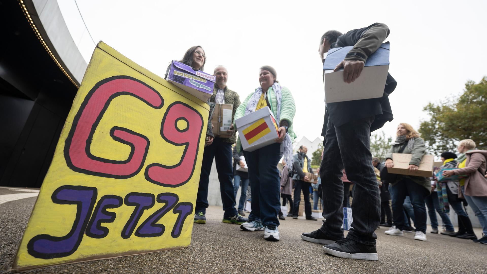 Baden-Württemberg, Stuttgart: Unterstützer der Elternintiative "G9 Jetzt! BW" stehen mit Kartons, in denen sich Unterschriftenlisten befinden, vor dem Eingang des Bürger- und Medienzentrum des Landtags von Baden-Württemberg. Baden-Württemberg, Stuttgart: Unterstützer der Elternintiative "G9 Jetzt! BW" stehen mit Kartons, in denen sich Unterschriftenlisten befinden, vor dem Eingang des Bürger- und Medienzentrum des Landtags von Baden-Württemberg.