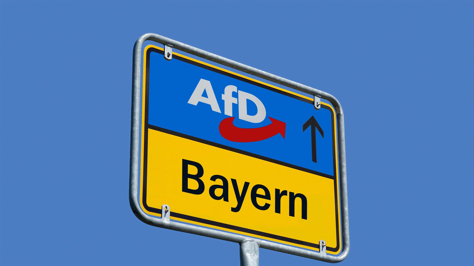 Auf einem Ortsschild befindet sich das Parteilogo der AfD und der Schriftzug Bayern Auf einem Ortsschild befindet sich das Parteilogo der AfD und der Schriftzug Bayern
