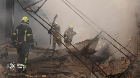 Dieses vom ukrainischen staatlichen Katastrophenschutzdienst veröffentlichte Foto zeigt Feuerwehrleute bei der Löschung eines Brandes, der wegen russischer Raketenangriffe auf die Hauptstadt Kiew ausgebrochen war.