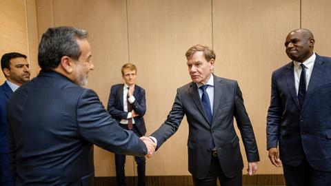 Deutschlands Außenminister Johann Wadephul (M, CDU) begrüßt den iranischen Außenminister Abbas Araghtschi (l) mit einem Handschlag. Rechts von Wadephul steht der britische Außenminister David Lammy. 