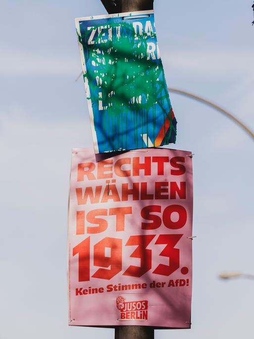 Ein beschmiertes Wahlplakat der Partei Alternative für Deutschland (AfD) sowie ein Plakat der JUSOS ("Rechts wählen ist so 1933"), aufgenommen in Berlin, 20.02.2025.