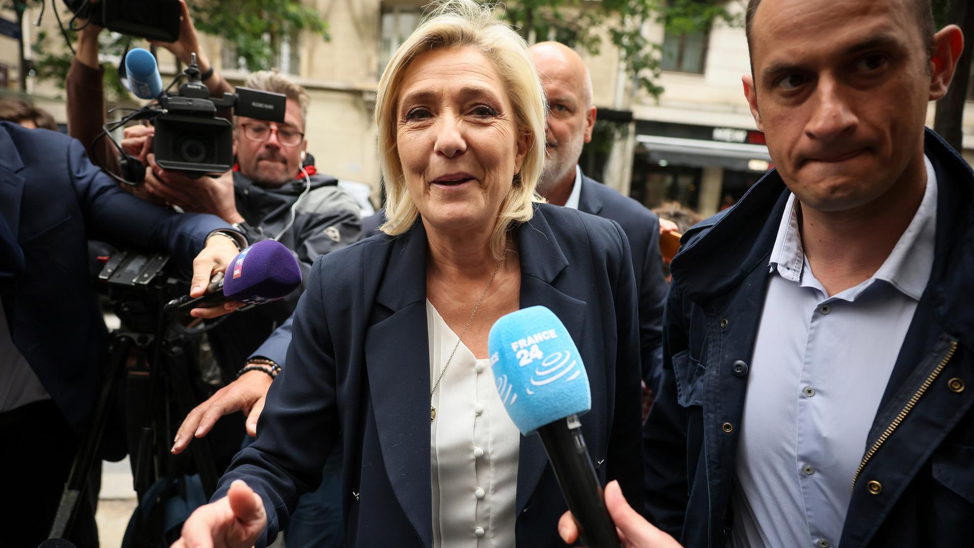 Marine Le Pen, umringt von Journalisten und ihren Mikrofonen