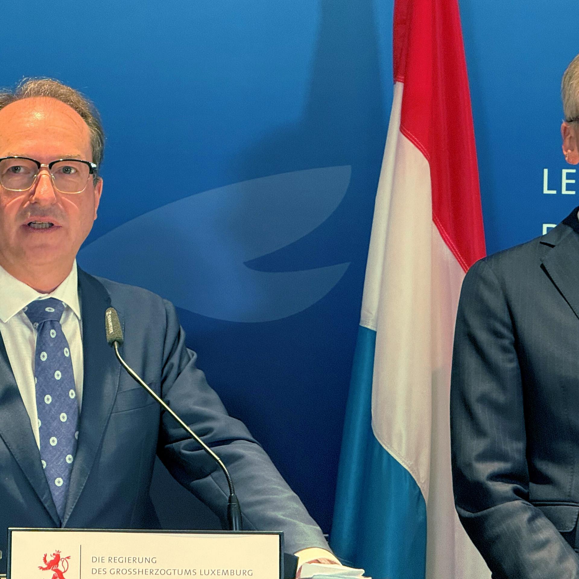 Bundesinnenminister Alexander Dobrindt (CSU) und Luxemburgs Innenminister Léon Gloden während einer Pressekonferenz, zwischen ihnen steht die luxemburgische Landesflagge