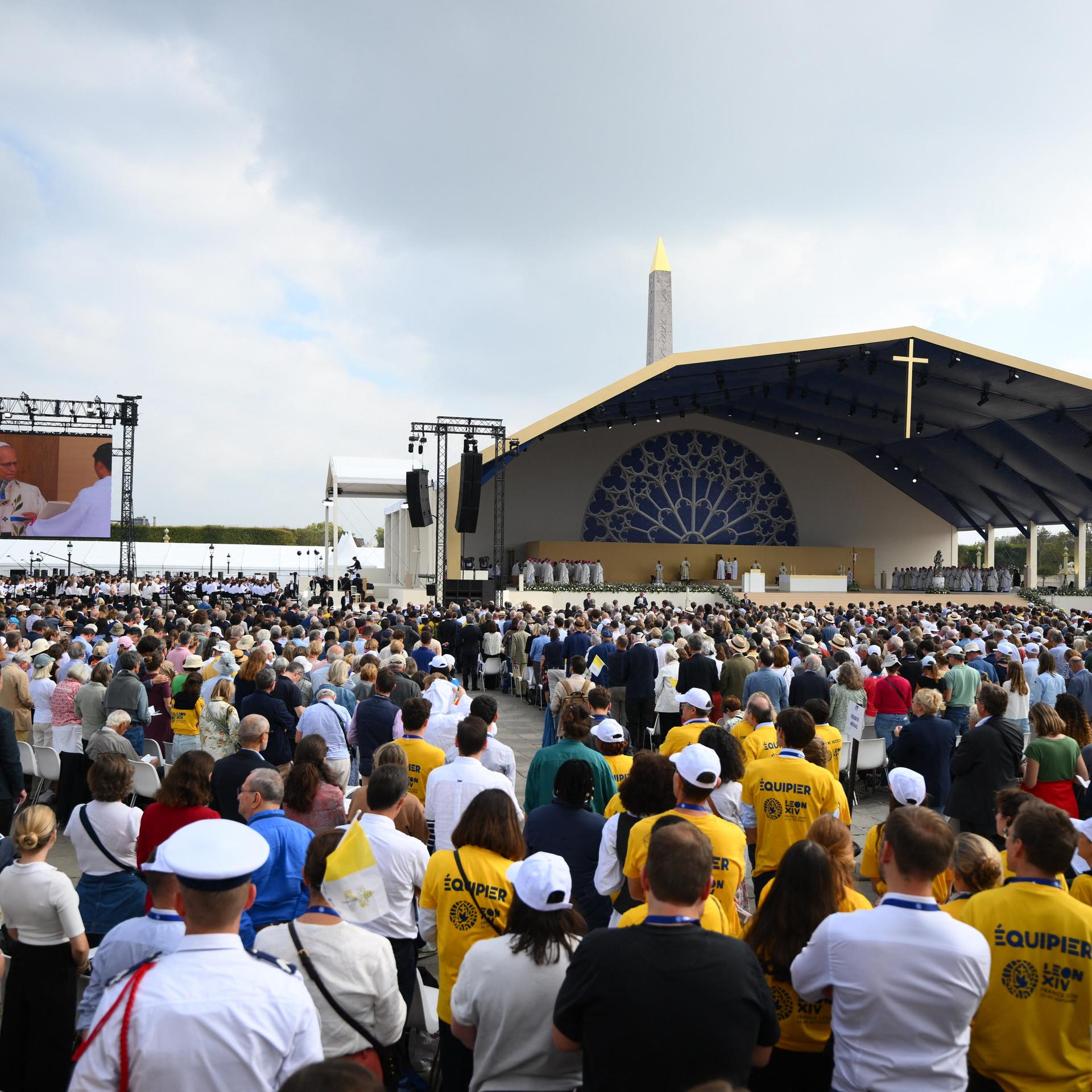 Der Papst feiert vor hunderttausenden Menschen eine Messe auf der Place de la Concorde in Paris. Zu sehen sind Menschenmassen, im Hintergrund die Bühne mit Papst Leo XIV. 