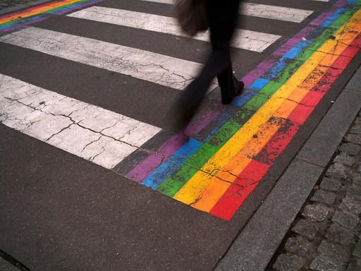 Mensch geht über Zebrastreifen.