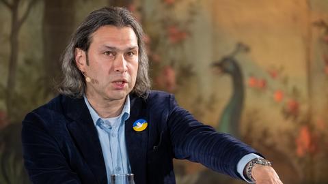 Auf dem Bild ist der Dirigent Vladimir Jurowski zu sehen. Er trägt ein blaues Jackett. 