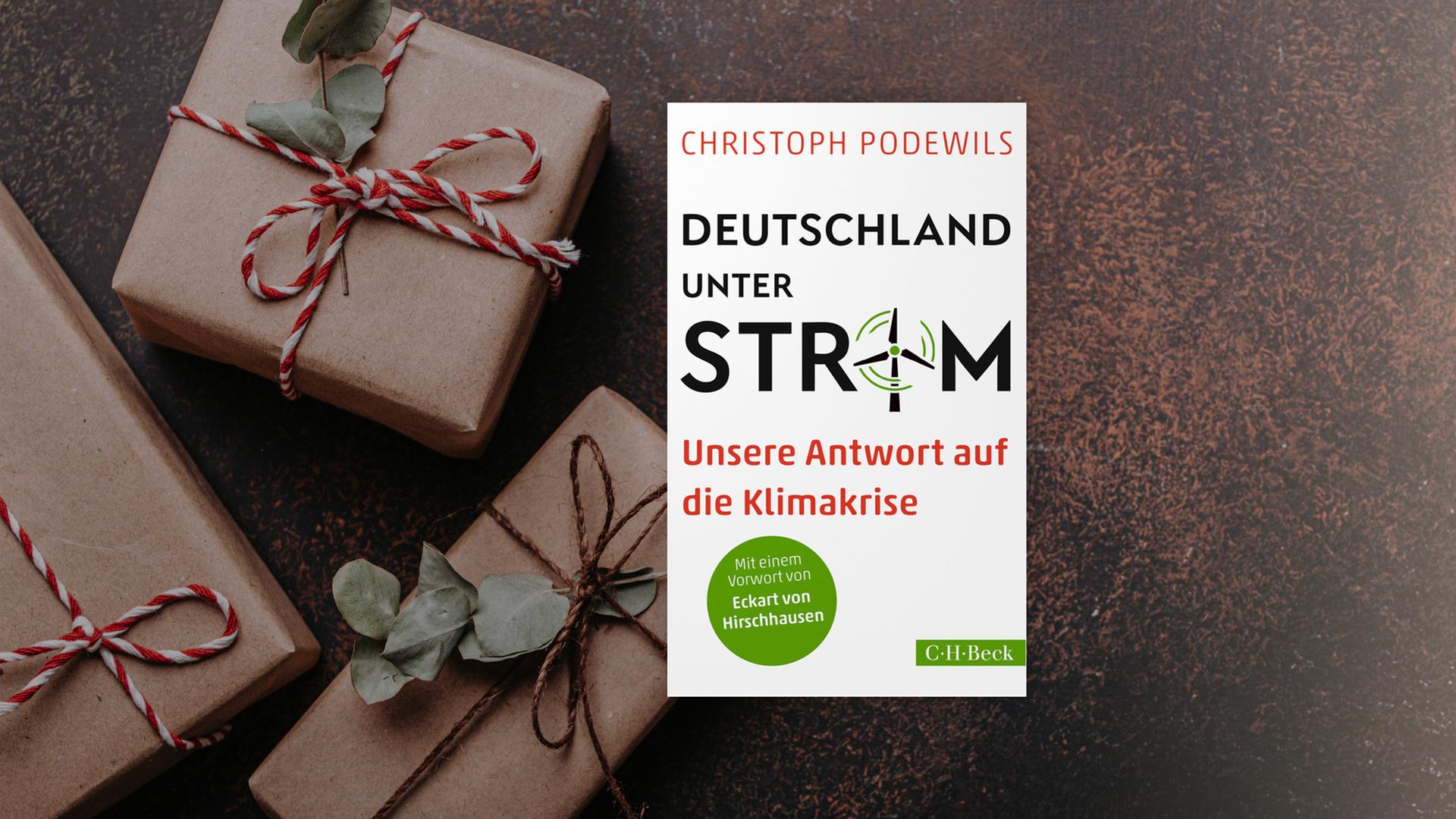 Buchcover von "Deutschland unter Strom" von Christoph Podewils.  Im Hintergrund sind graue Päckchen mit rot-weißen Schleifen zu sehen. 