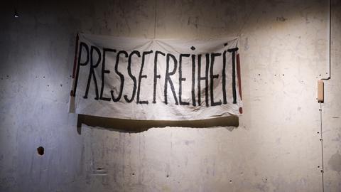 Ein Transparent mit der Aufschrift "Pressefreiheit" hängt vor einer unverputzten Wand. Es stammt aus den Dreharbeiten zum historischen ZDF-Dreiteiler "The Wall".