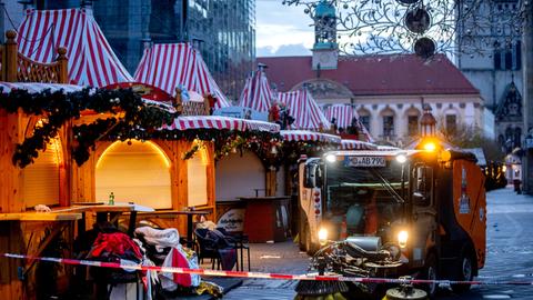 Public workers clean the Christmas Market, where a car drove into a crowd on Friday evening, in Magdeburg, Germany, is empty on Sunday morning , Dec. 22, 2024. (AP Photo/Michael Probst)