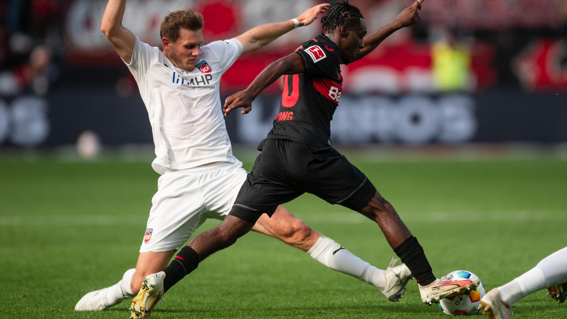 Das Foto zeigt einen Spielszene der Partie Bayer Leverkusen gegen1. FC Heidenheim. Zwei Spieler kämpfen um den Ball.