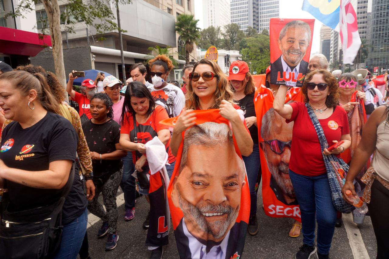 Eine Gruppe von Frauen ganz in Rot zieht mit Plakaten und Postern von Lula da Silva durch die Straßen der Stadt.