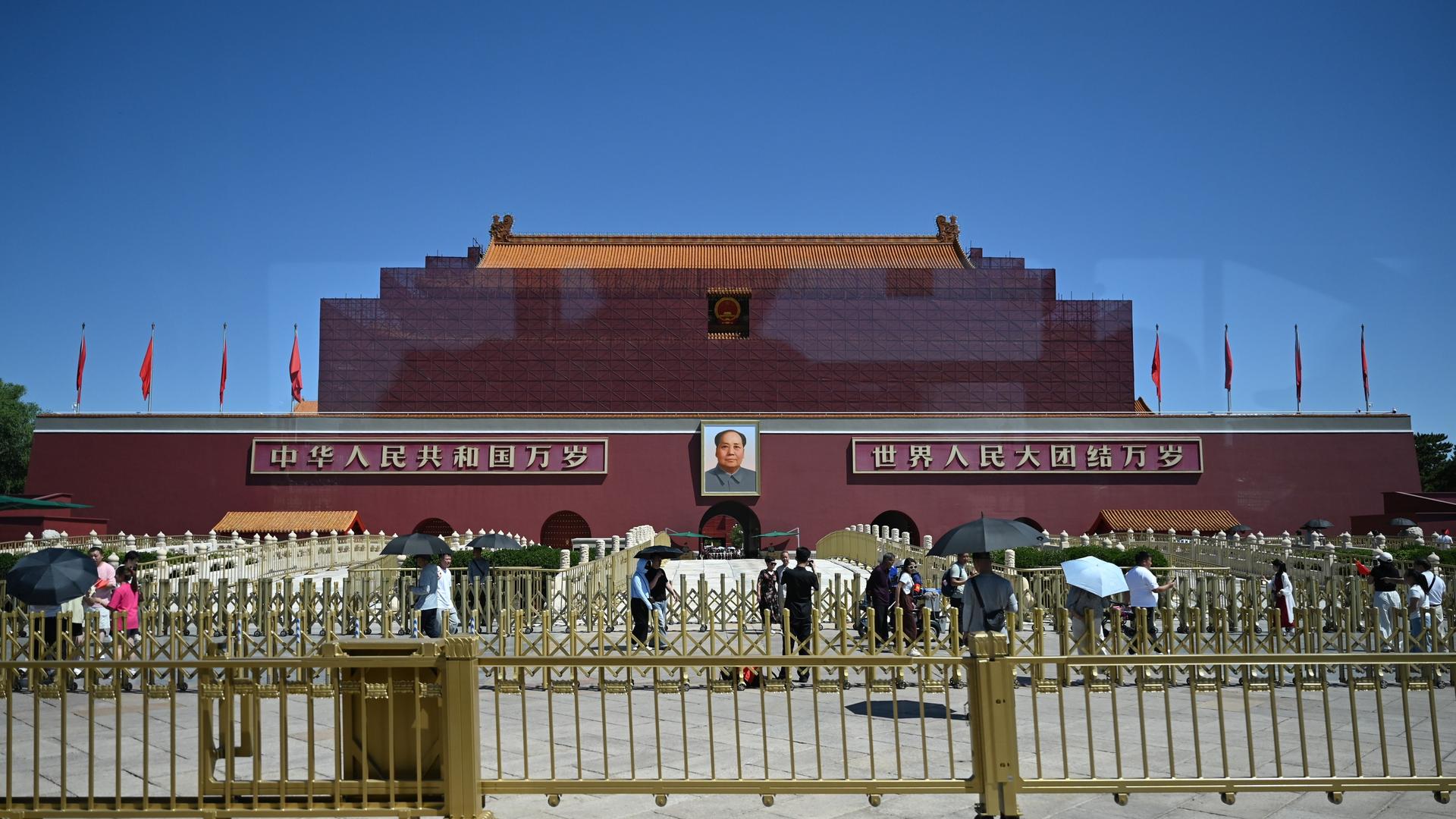 Peking: Menschen laufen vor dem von einem Baugerüst umringten Himmelstor mit dem Konterfei Mao Zedongs am Platz des Himmlischen Friedens (Tiananmen) vorbei. Peking: Menschen laufen vor dem von einem Baugerüst umringten Himmelstor mit dem Konterfei Mao Zedongs am Platz des Himmlischen Friedens (Tiananmen) vorbei.