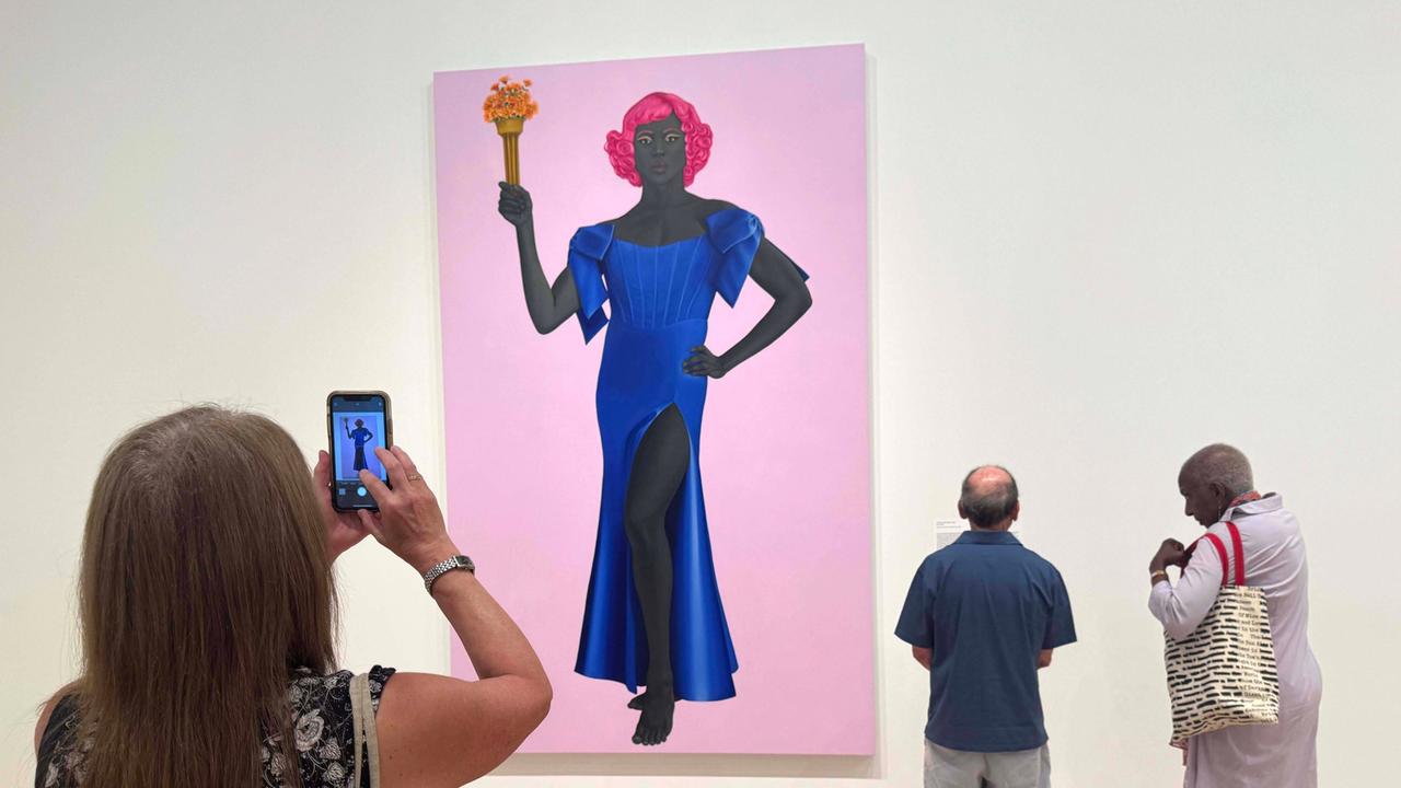 August 8, 2025, New York, New York, USA: Museum goers view the painting TRANS FORMING LIBERTY, 2024, seen at the exhibition of artist Amy Sherald: American Sublime held at the Whitney Museum of American Art. Amy Sherald cancelled her upcoming solo exhibition at the SmithsonianÃââ s National Portrait Gallery due censorship concerns due to the musuemÃââ s hesitation to include this painting which depicts a transgender woman as the Statue of Liberty. New York USA - ZUMAk03_ 20250808_zaf_k03_133 Copyright: xNancyxKaszermanx