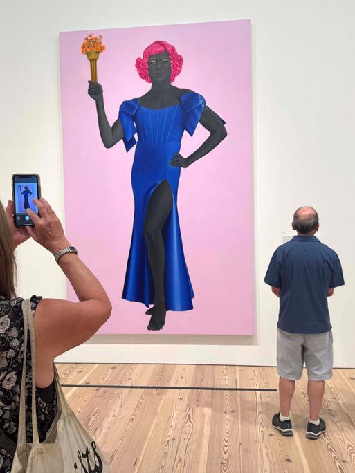 August 8, 2025, New York, New York, USA: Museum goers view the painting TRANS FORMING LIBERTY, 2024, seen at the exhibition of artist Amy Sherald: American Sublime held at the Whitney Museum of American Art. Amy Sherald cancelled her upcoming solo exhibition at the SmithsonianÃââ s National Portrait Gallery due censorship concerns due to the musuemÃââ s hesitation to include this painting which depicts a transgender woman as the Statue of Liberty. New York USA - ZUMAk03_ 20250808_zaf_k03_133 Copyright: xNancyxKaszermanx