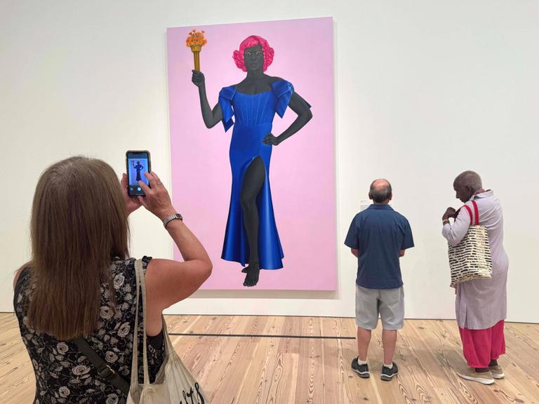 August 8, 2025, New York, New York, USA: Museum goers view the painting TRANS FORMING LIBERTY, 2024, seen at the exhibition of artist Amy Sherald: American Sublime held at the Whitney Museum of American Art. Amy Sherald cancelled her upcoming solo exhibition at the SmithsonianÃââ s National Portrait Gallery due censorship concerns due to the musuemÃââ s hesitation to include this painting which depicts a transgender woman as the Statue of Liberty. New York USA - ZUMAk03_ 20250808_zaf_k03_133 Copyright: xNancyxKaszermanx
