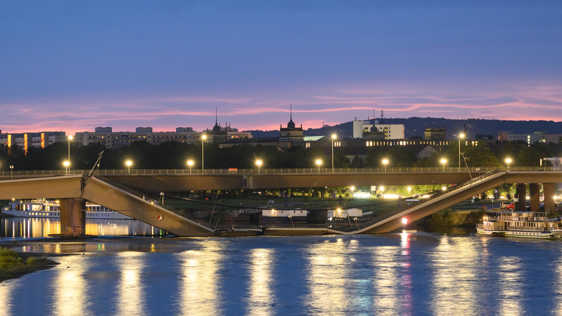 Die in Teilen eingestürzte Carolabrücke über der Elbe in Dresden im Abendlicht. Die in Teilen eingestürzte Carolabrücke über der Elbe in Dresden im Abendlicht.
