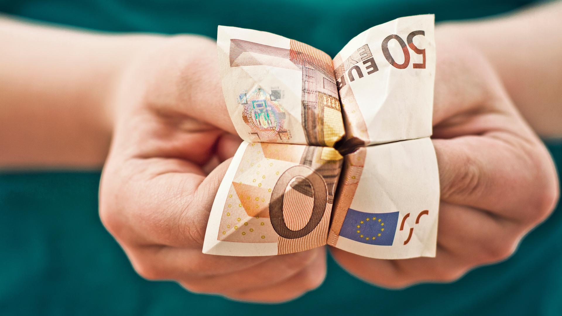 Kinderhände, die einen aus einem 50-Euro-Schein gebastelten Papier-Wahrsager halten. Kinderhände, die einen aus einem 50-Euro-Schein gebastelten Papier-Wahrsager halten.