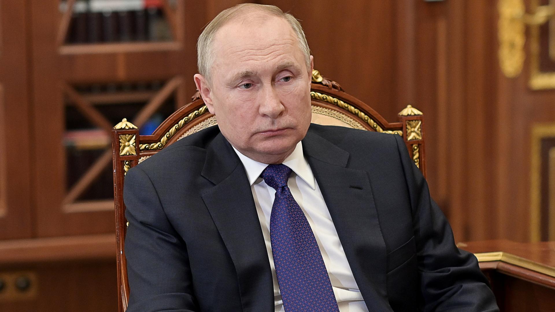 Der russische Präsident Putin sitzt an einem Schreibtisch. Der russische Präsident Putin sitzt an einem Schreibtisch.