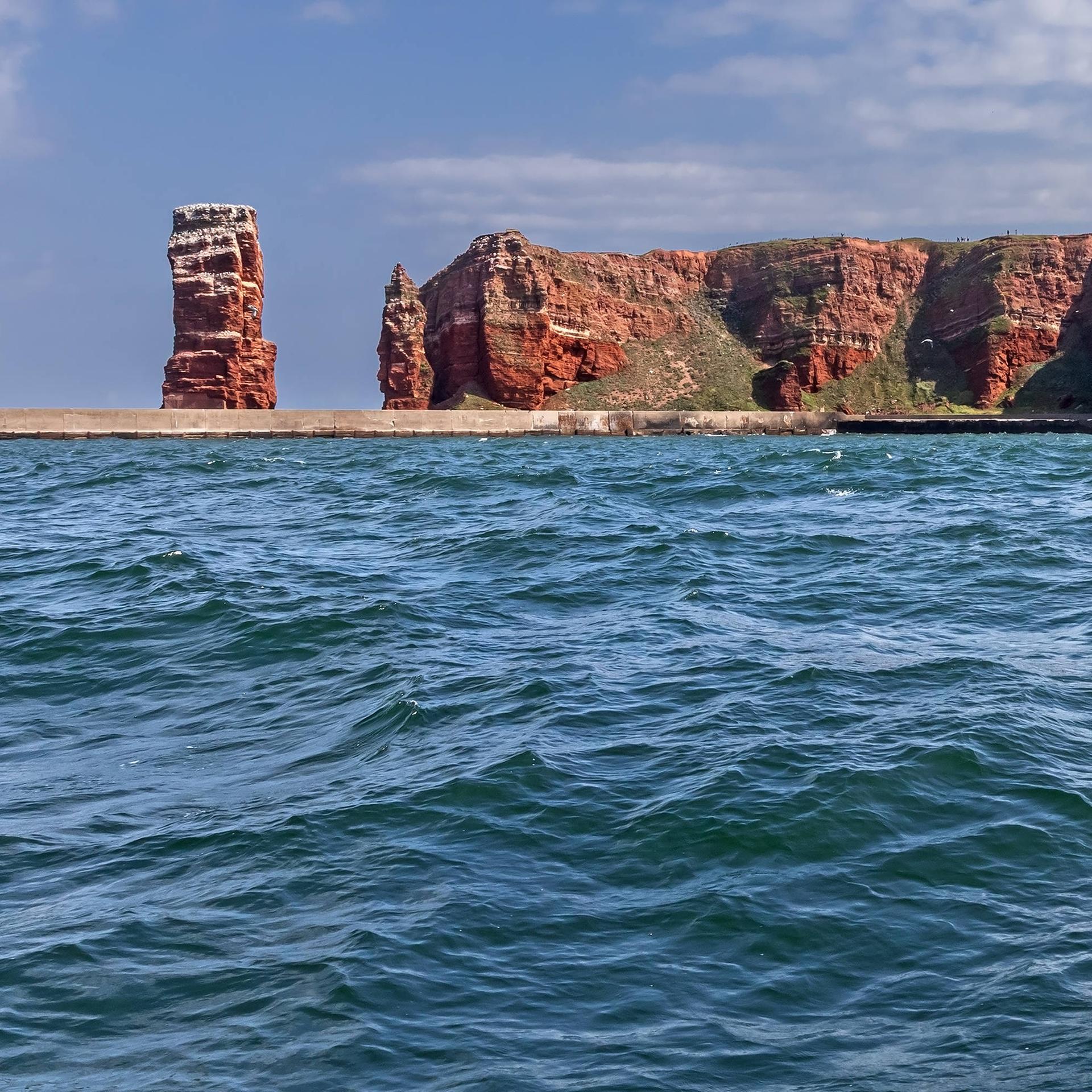 Nordsee mit Wellen und Buntsandsteinklippen von Helgoland mit der Langen Anna Nordsee mit Wellen und den Buntsandsteinklippen der Insel Helgoland mit der Langen Anna.