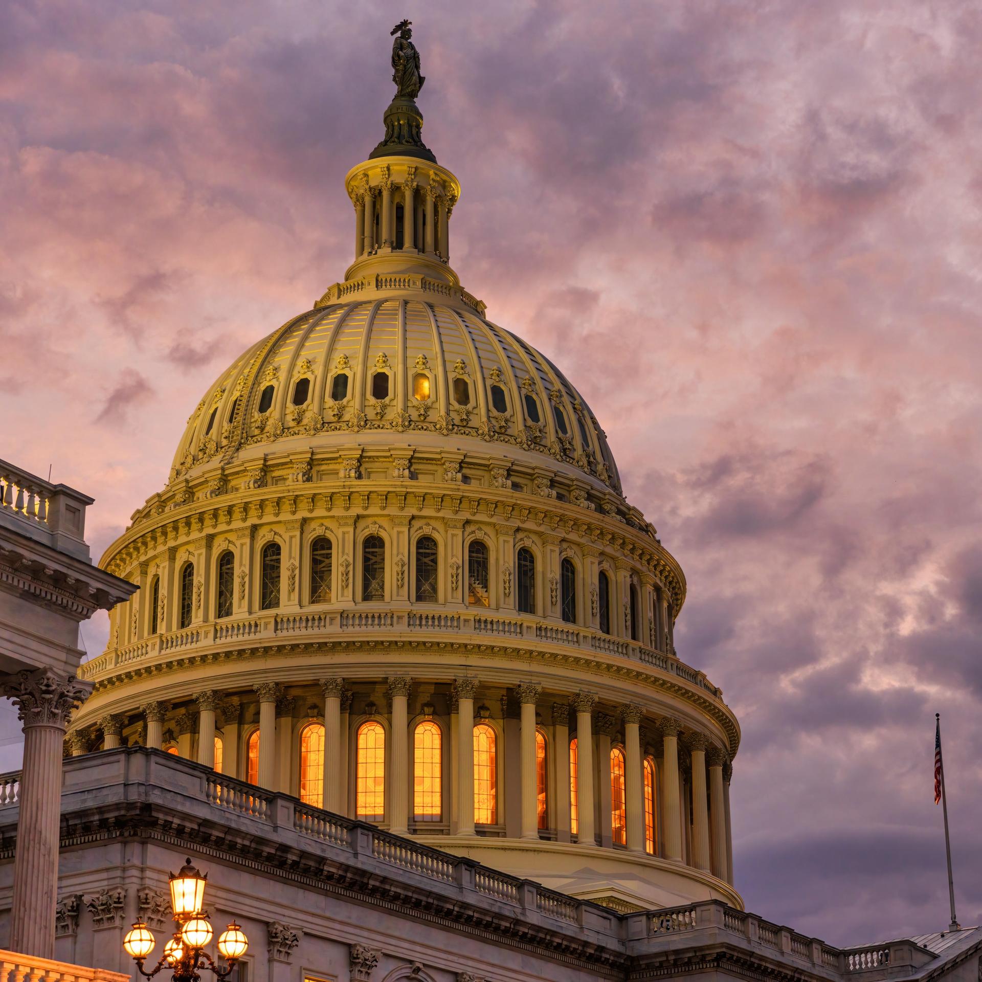 Violet sunset sky over the US Capitol building dome