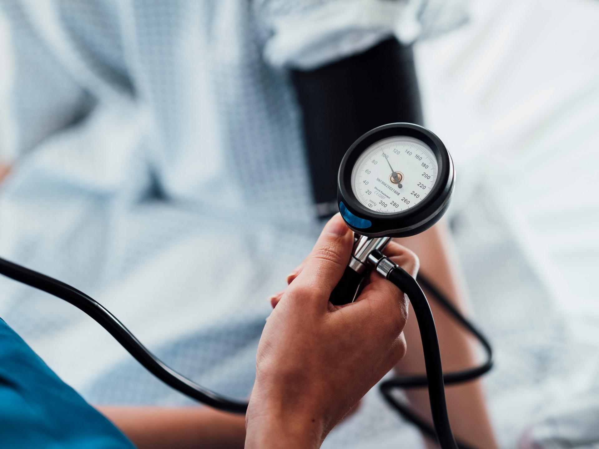 Ein Blutdruckmessgerät am Arm eines Patienten