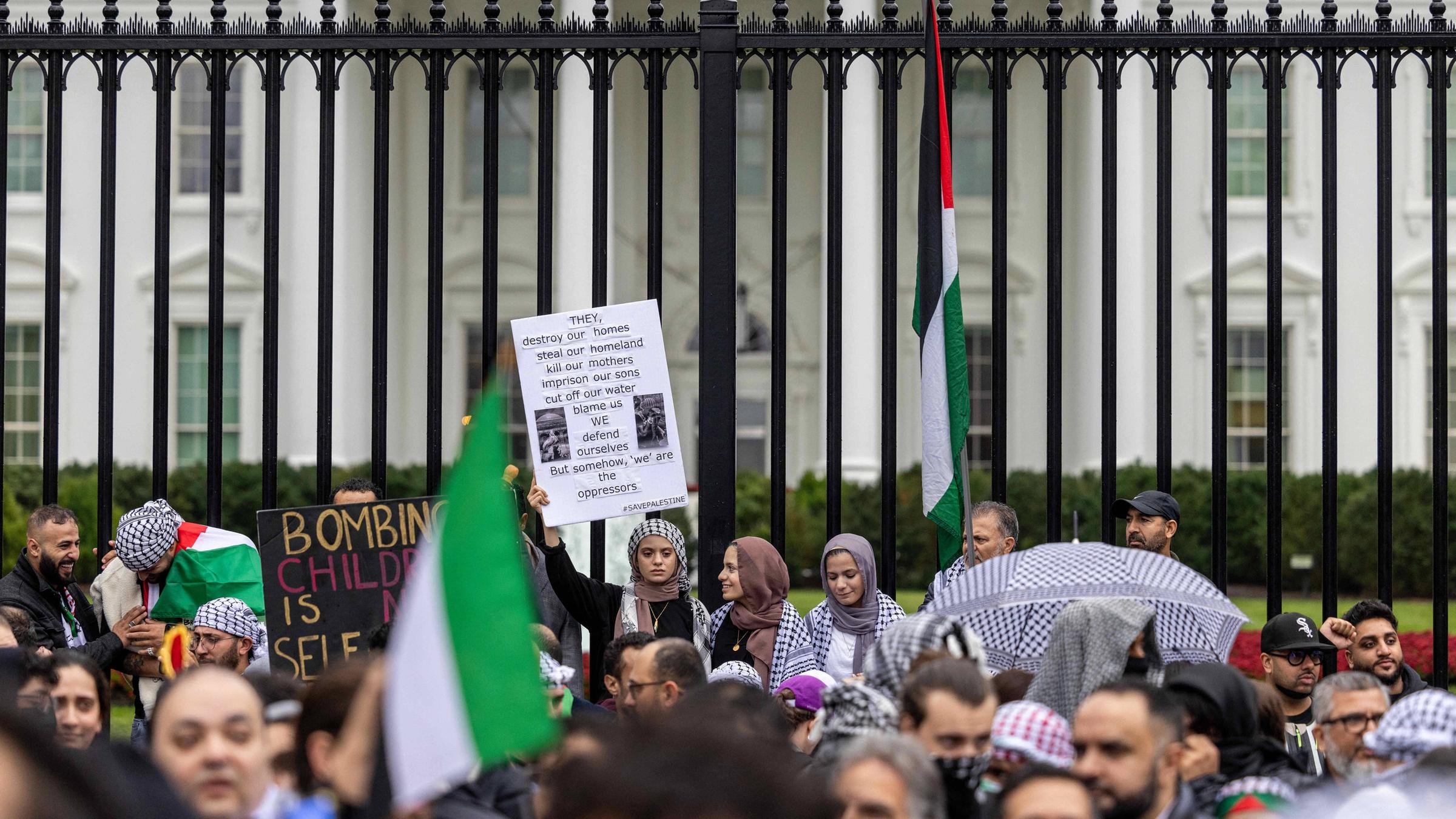 Eine Gruppe von Demonstranten hält pro-palästinensische Plakate vor dem Weißen Haus hoch.
