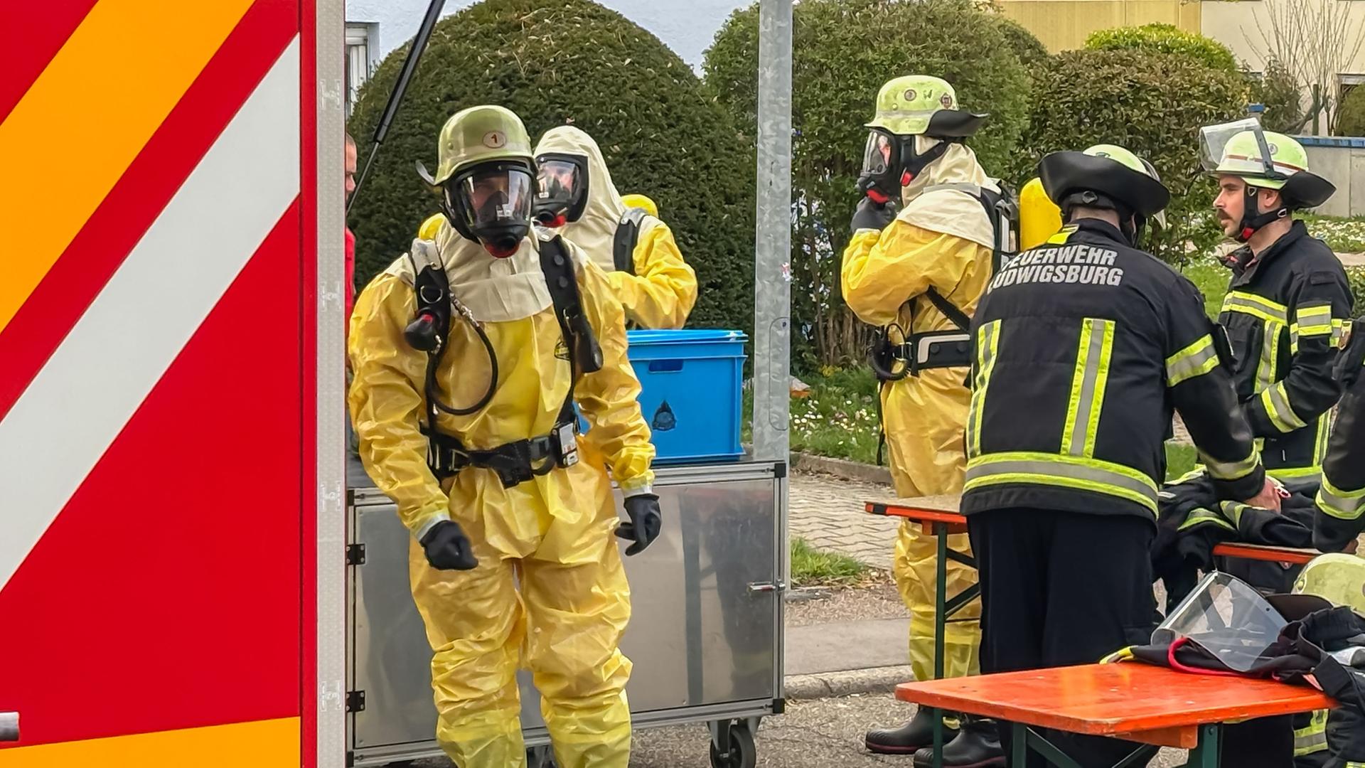 Vaihingen an der Enz: Einsatzkräfte der Feuerwehr in Schutzanzügen sind in einem Wohngebiet im Einsatz.