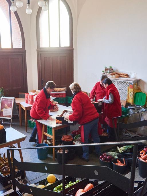 Ehrenamtliche Helfe der Tafel Laib und Seele" 2018 bei der Essensausgabe in einem Vorraum der Berliner Advent-Zachäus Kirche. 