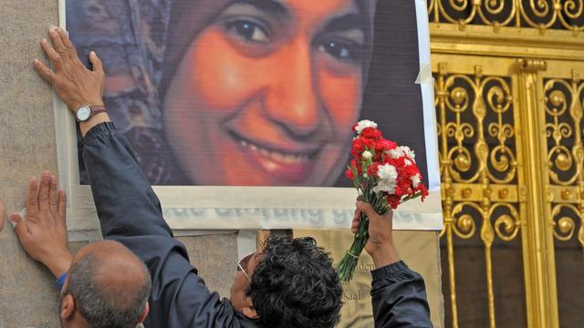 Vor dem Dresdner Rathaus kleben am Samstag (11.07.2009) zwei Männer ein Foto der am Mittwoch (01.07.2009) im Dresdner Landgericht erstochenen Ãgypterin Marwa El-Sherbini an die Wand.