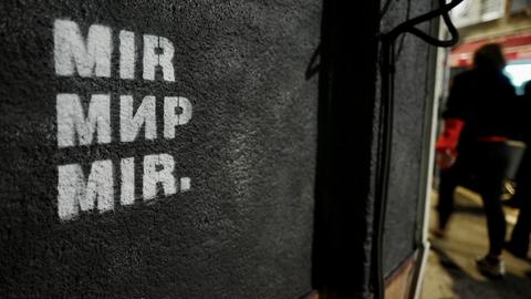 An einer schwarzen Hauswand steht in weißer Schrift "Mir", das Wort für Frieden in drei Sprachen: Bosnisch, Kroatisch, Serbisch.