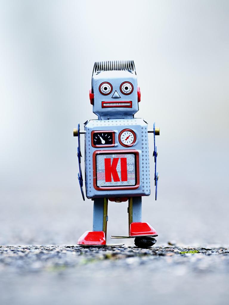 Eine Fotomontage zeigt eine Roboterfigur mit der Aufschrift KI. Eine Fotomontage zeigt eine Roboterfigur mit der Aufschrift KI.