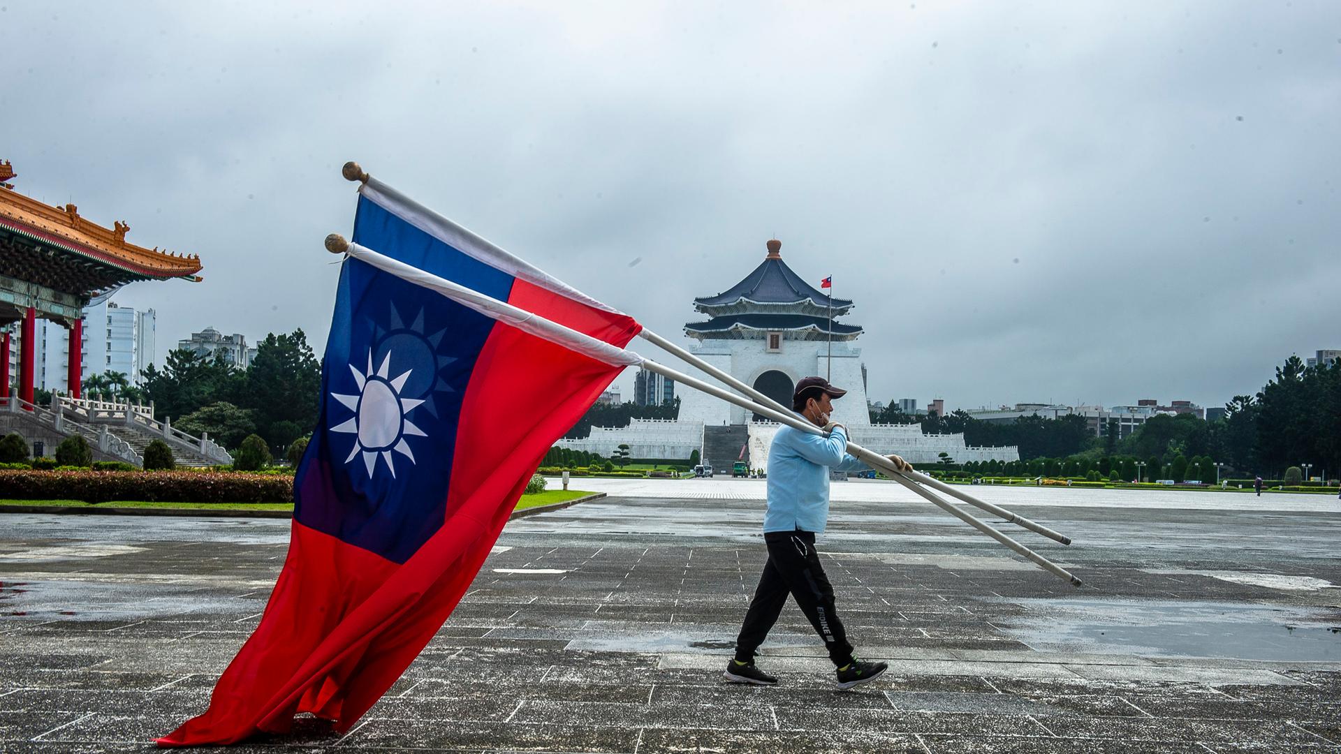 November 3, 2022, Taipei, Taiwan: A man carries flags of the Republic of China in the Liberty Square in front of Chiang Kai-shek mausoleum in Taipei. A group of eight European lawmakers, two of them sanctioned by Beijing, are set to arrive in Taiwan amid renewed geopolitical uncertainties after the Chinese ruling party's top congress. (Credit Image: Â© Wiktor Dabkowski/ZUMA Press Wire