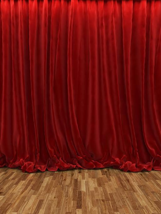 Ein geschlossener roter Samtvorhang in einem Theater.