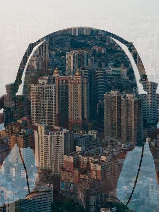 double exposure of man listening to headphones and cityscape,shenzhen,china