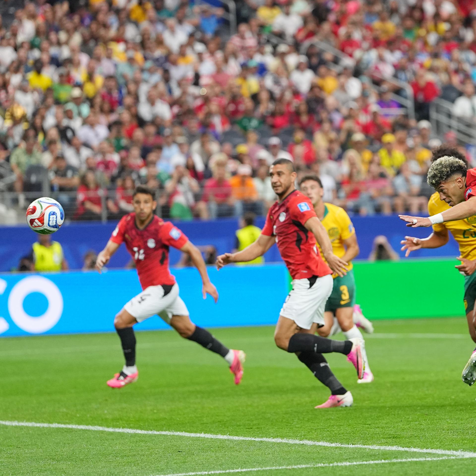Zu sehen sind mehrere Fußballspieler der Mannschaften von Ägypten und Australien. Ein ägyptischer Spieler hat einen Kopfball ausgeführt. 
