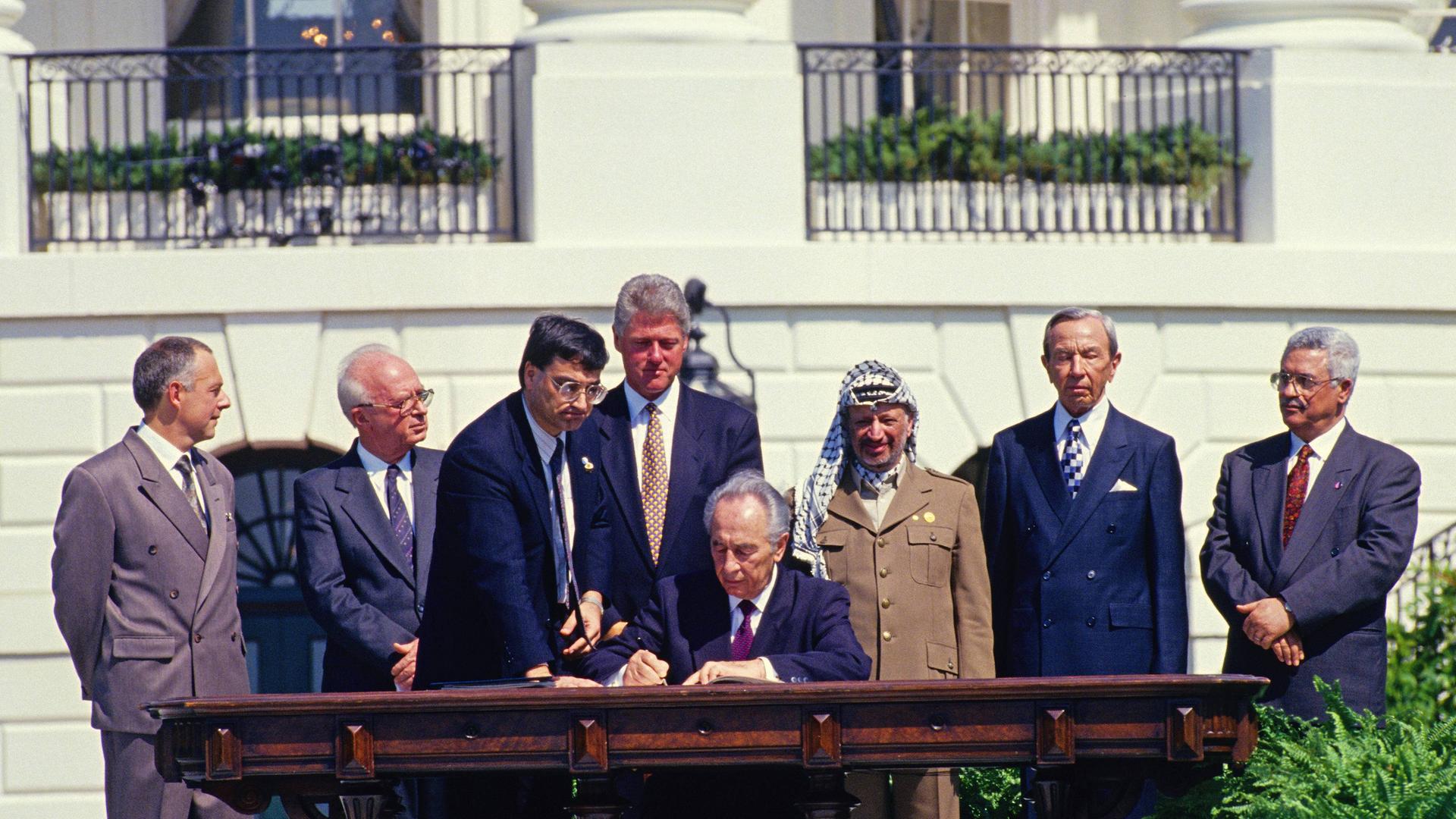 September 13, 1993 - Washington, District of Columbia, United States of America - Minister of Foreign Affairs of Israel Shimon Peres puts his signature on the agreement during the signing ceremony of the historic Israeli-PLO Agreement, known as the Oslo 1 Accord, on the South Lawn of the White House in Washington, DC on September 13, 1993. Pictured, from left to right: From left to right are: Foreign Minister Andrei Kozyrev of Russia; Prime Minister Yitzhak Rabin of Israel; unknown aide; United States President Bill Clinton; Peres; Chairman Yasser Arafat of the Palestine Liberation Organization (PLO); US Secretary of State Warren Christopher; and Arafat aide Mahmoud Abbas..Credit: / CNP Washington United States of America PUBLICATIONxINxGERxSUIxAUTxONLY - ZUMAs152September 13 1993 Washington District of Columbia United States of America Ministers of Foreign Affairs of Israel Shimon Peres Puts His Signature ON The Agreement during The Signing Ceremony of The Historic Israeli PLO Agreement known As The Oslo 1 Accord ON The South Lawn of The White House in Washington DC ON September 13 1993 Pictured from left to Right from left to Right are Foreign Ministers Andrei Kozyrev of Russia Prime Ministers Yitzhak Rabin of Israel Unknown Aide United States President Bill Clinton administration Peres Chairman Yasser Arafat of The Palestine Liberation Organization PLO U.S. Secretary of State Warren Christopher and Arafat Aide Mahmoud Abbas Credit CNP Washington United States of America PUBLICATIONxINxGERxSUIxAUTxONLY ZUMAs152  