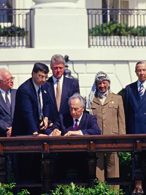 September 13, 1993 - Washington, District of Columbia, United States of America - Minister of Foreign Affairs of Israel Shimon Peres puts his signature on the agreement during the signing ceremony of the historic Israeli-PLO Agreement, known as the Oslo 1 Accord, on the South Lawn of the White House in Washington, DC on September 13, 1993. Pictured, from left to right: From left to right are: Foreign Minister Andrei Kozyrev of Russia; Prime Minister Yitzhak Rabin of Israel; unknown aide; United States President Bill Clinton; Peres; Chairman Yasser Arafat of the Palestine Liberation Organization (PLO); US Secretary of State Warren Christopher; and Arafat aide Mahmoud Abbas..Credit: / CNP Washington United States of America PUBLICATIONxINxGERxSUIxAUTxONLY - ZUMAs152September 13 1993 Washington District of Columbia United States of America Ministers of Foreign Affairs of Israel Shimon Peres Puts His Signature ON The Agreement during The Signing Ceremony of The Historic Israeli PLO Agreement known As The Oslo 1 Accord ON The South Lawn of The White House in Washington DC ON September 13 1993 Pictured from left to Right from left to Right are Foreign Ministers Andrei Kozyrev of Russia Prime Ministers Yitzhak Rabin of Israel Unknown Aide United States President Bill Clinton administration Peres Chairman Yasser Arafat of The Palestine Liberation Organization PLO U.S. Secretary of State Warren Christopher and Arafat Aide Mahmoud Abbas Credit CNP Washington United States of America PUBLICATIONxINxGERxSUIxAUTxONLY ZUMAs152  