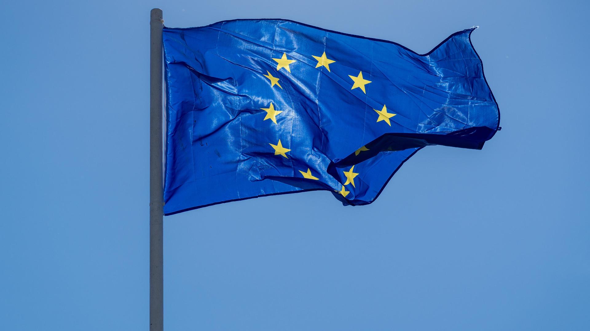 Die Flagge der Europäischen Union weht vor wolkenlosem Himmel Die Flagge der Europäischen Union weht vor wolkenlosem Himmel